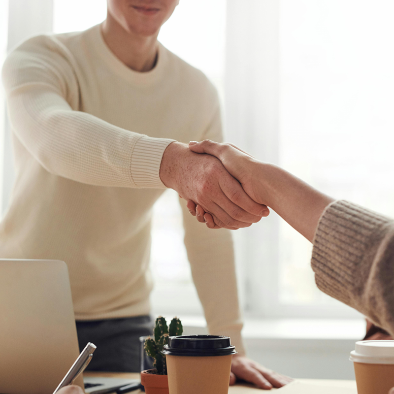 refinance_1 Person shaking hands with someone across a table